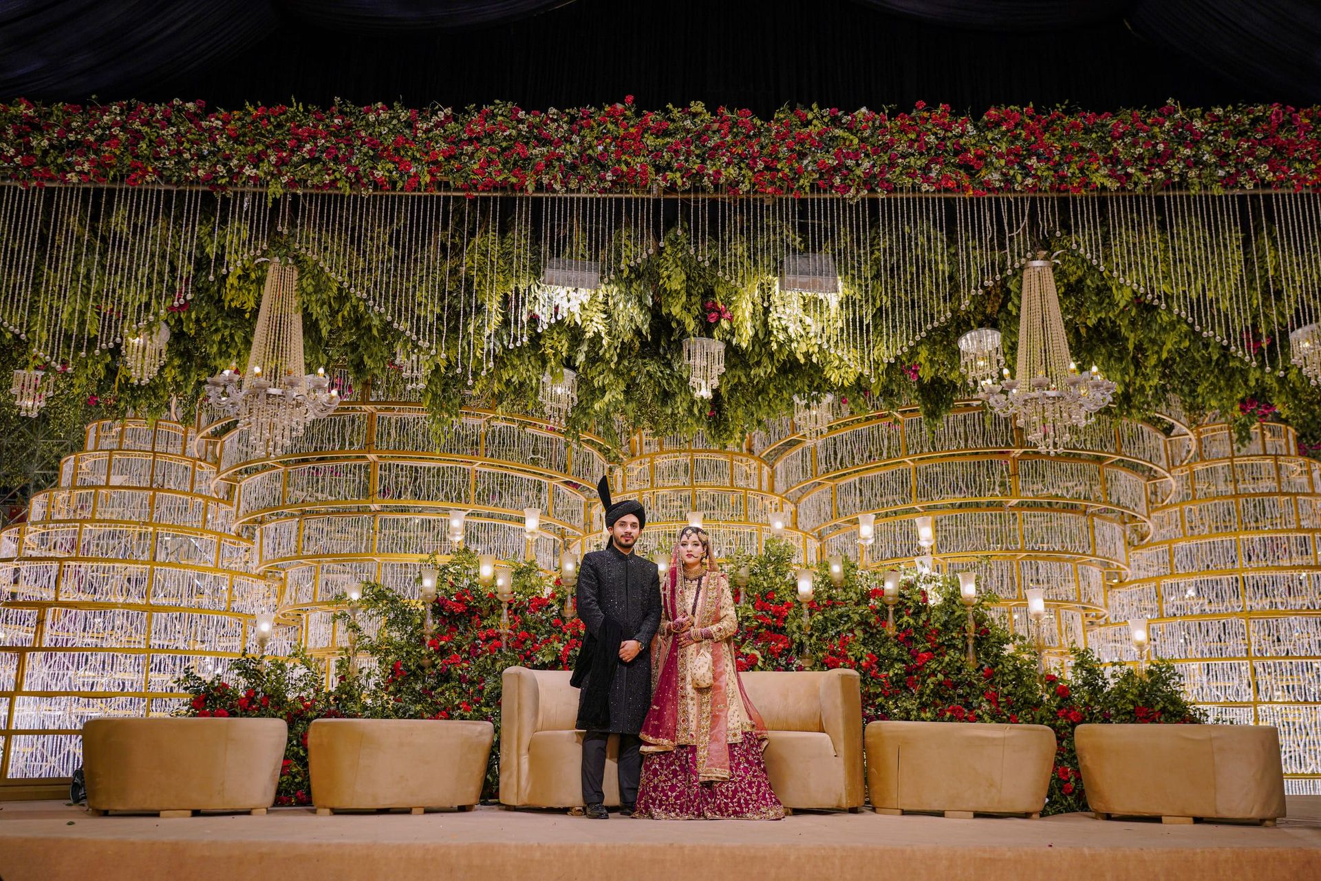Bride and groom on a grand floral reception stage, Lahore walima photography